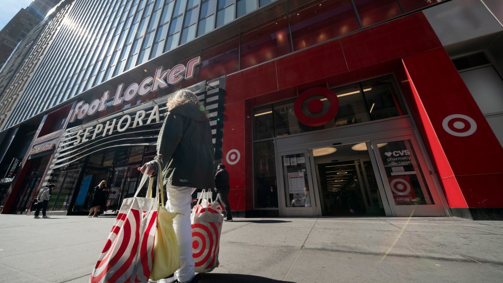 A woman carries Target shopping bags as she leaves the store, Monday, April 19, 2021 in New York. Retail sales in the U.S. were flat in April, after soaring in March, when many Americans received $1,400 stimulus checks that boosted spending. The report from the U.S. Commerce Department was worse than the 0.8% growth Wall Street analysts had expected.    (AP Photo/Mark Lennihan)