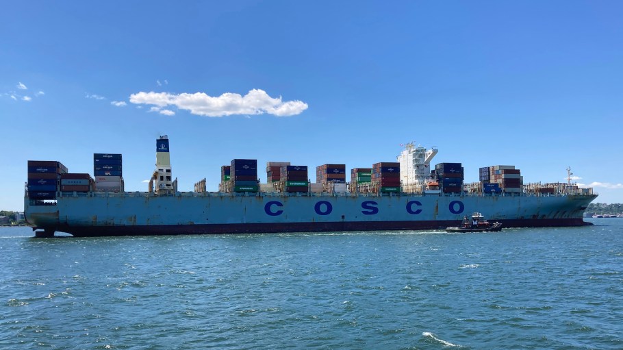 A cargo ship is escorted into port near the Verrazano Narrows. The global shortage of shipping containers, brought on by the Covid-19 pandemic, has created drastic inflation in shipping and container prices and increased delay times for companies.