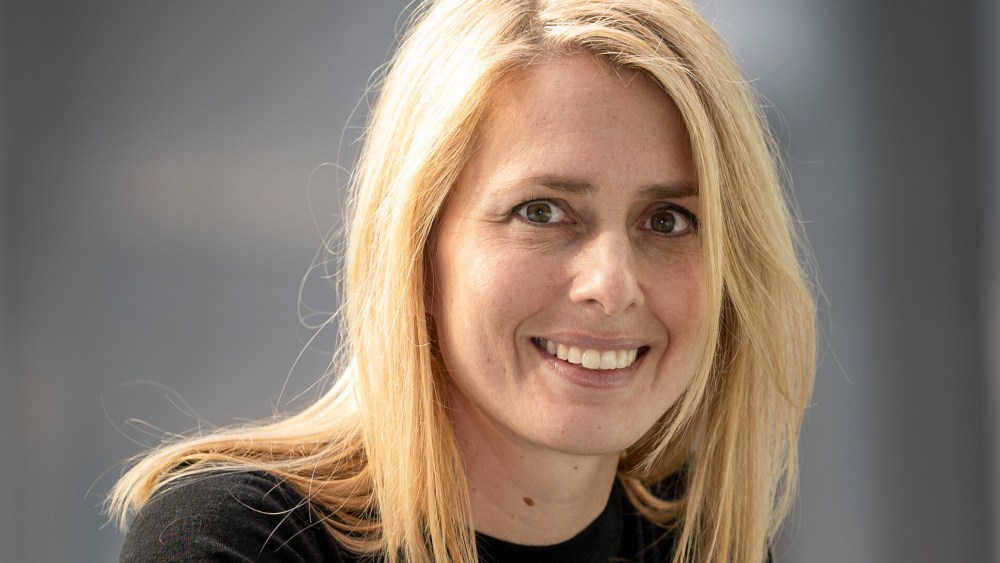 Helena Helmersson wearing a black three-quarter sleeved top and smiling in a simple pose.