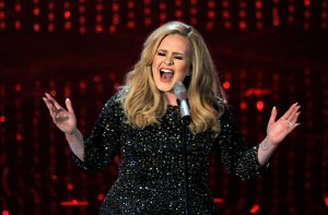 FILE - In this Feb. 24, 2013 file photo, Adele performs during the Oscars at the Dolby Theatre in Los Angeles. Adeles Hello single has become the first song to sell one million tracks in a week. Her comeback track sold 1.11 million digital songs, setting a new record. Her complete album "25," will be released on Nov. 20. (Photo by Chris Pizzello/Invision/AP, File)