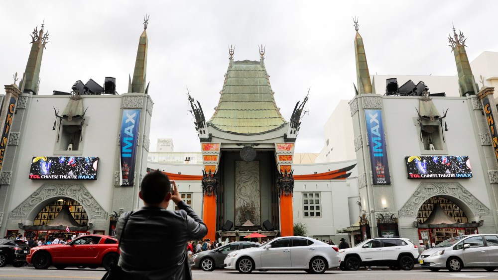 In this May 15, 2017 photo, a tourist take pictures of the TCL Chinese Theatre in the Hollywood section of Los Angeles. The storied Hollywood Boulevard movie palace, originally named Grauman’s Chinese Theatre, opened its doors on May 18, 1927. (AP Photo/Jae C. Hong)