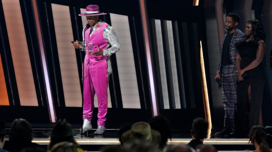 New Artist of the Year Jimmie Allen attended the CMA Awards in silver cowboy boots and a hot pink velvet outfit.