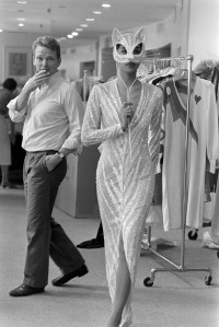 Designer Bob Mackie adjusts a garment on model Anna Bayle for his 1984-1985 Resort collection.