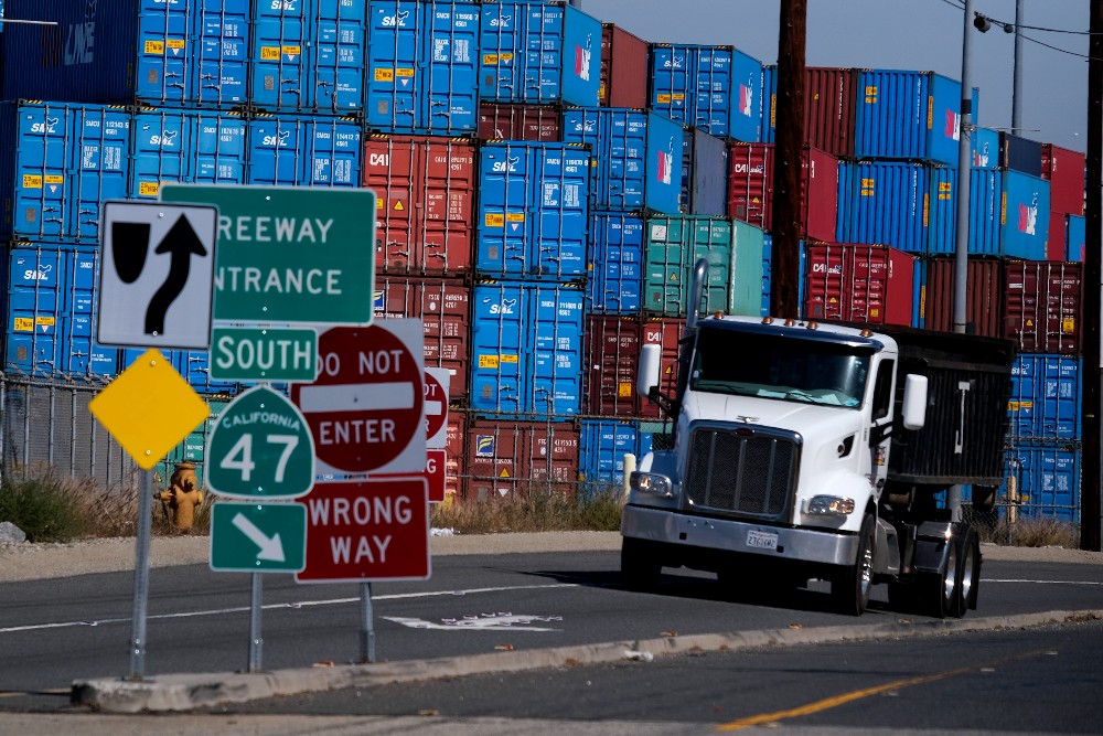 A truck leaves the San Pedro Bay complex, Oct. 20.