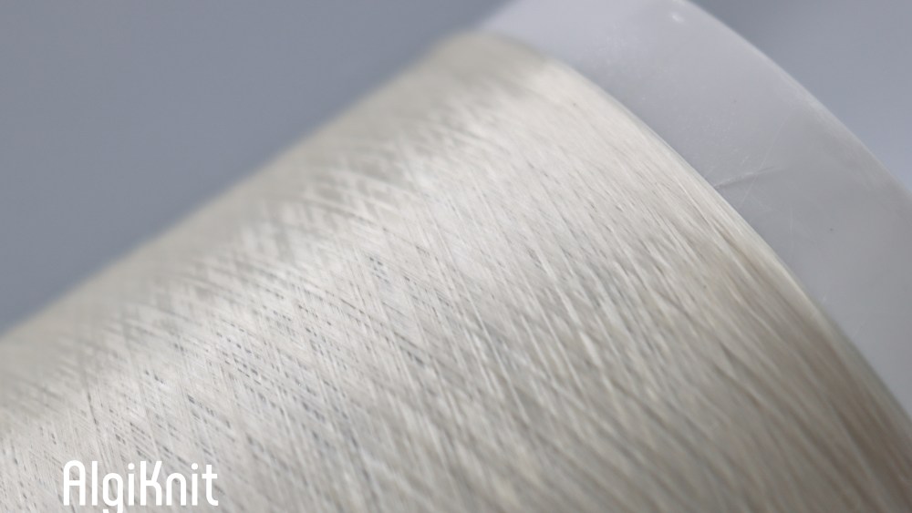 A closeup of seaweed-powered innovation Algiknit resembling a translucent thread.