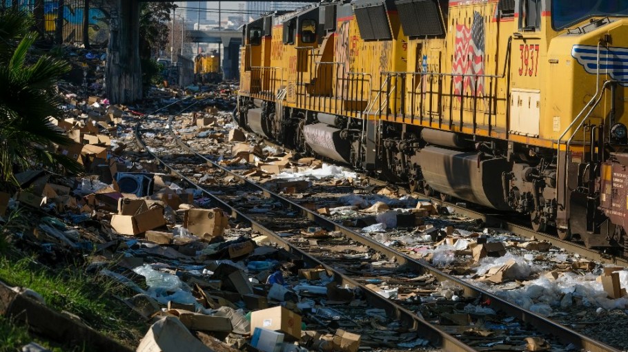 A train passes by as shredded boxes and packages at a section of the Union Pacific train tracks in downtown Los Angeles Friday, Jan. 14, 2022.