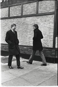 John B. Fairchild and Yves Saint Laurent on the street in New York during the designers tour of American in October 1965.