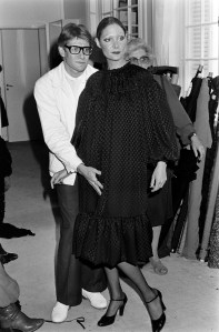 Yves Saint Laurent fits a model in his Couture Fall 1977 collection.