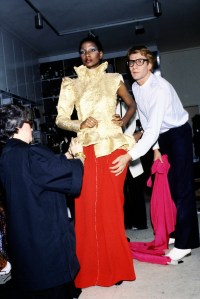 Yves Saint Laurent and assistants fit a look from the Yves Saint Laurent Couture Fall 1977 collection on model Mounia Orsemane at 5 avenue Marceau in Paris.