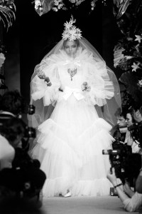 Mounia Orosemane poses in a bridal ensemble from the Yves Saint Laurent Couture Spring 1983 20th Anniversary runway show.