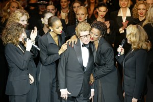 Yves Saint Laurent with muses Laetitia Casta, Georgianna Robertson, Mounia Orsemane and Catherine Deneuve close his Couture Spring 2002 show and retrospective at the Pompidou Centre in Paris, marking his retirement.