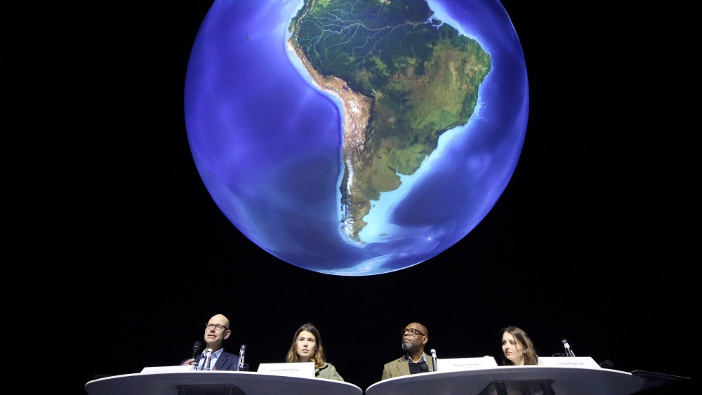 11 February 2022, North Rhine-Westphalia, Oberhausen: Niklas H'hne, New Climate Institute Cologne, Luisa Neubauer,Fridays for Future activist, Peter Donatus, journalist and activist, and Linda Kastrop, activist, (from left) stand in front of a giant globe in the exhibition "The Fragile Paradise" during the press conference. The participants give an outlook on planned actions in 2022 and speak on the topic of "greenwashing" in Brussels. Photo by: Roland Weihrauch/picture-alliance/dpa/AP Images