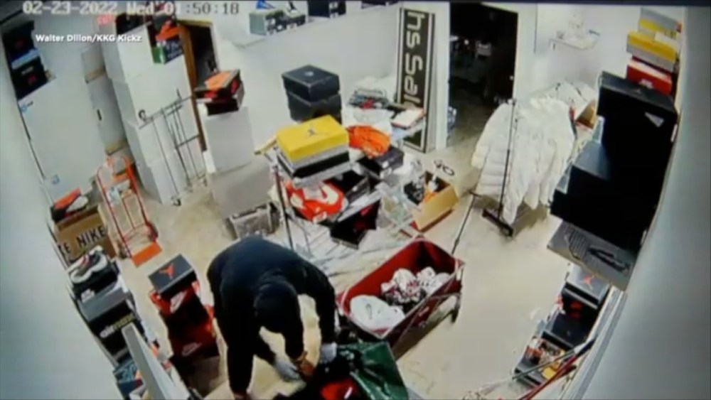 Surveillance footage shows a man burglarizing KKG Kickz on Wed., Feb. 23, 2022, in Little Canada, Minn. KKG Kickz, a boutique footwear store near Minneapolis, is closing after five burglaries targeted the small sneaker shop over six months.