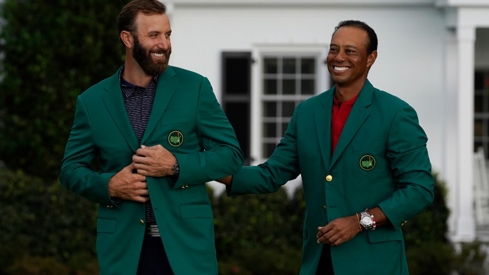 Tiger Woods stands next to Masters champion Dustin Johnson with his green jacket after his victory at the Masters golf tournament Sunday, Nov. 15, 2020, in Augusta, Ga. (AP Photo/Chris Carlson)