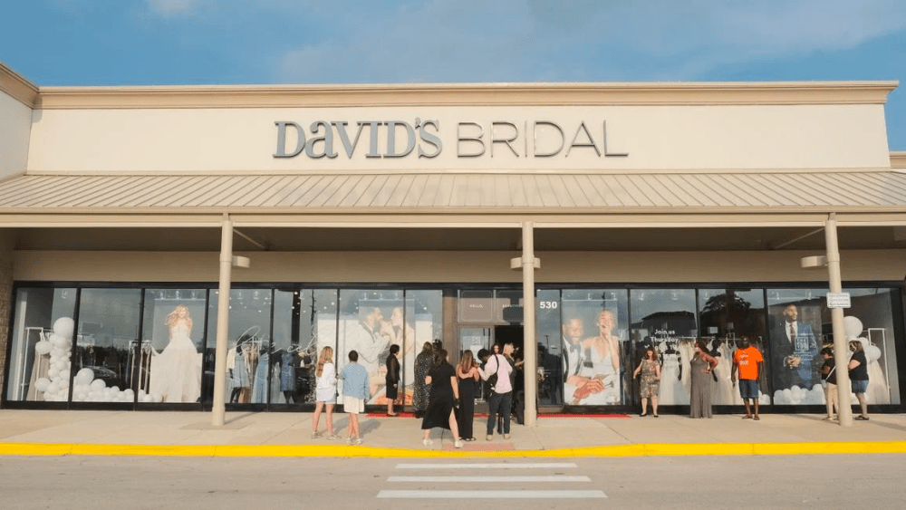 David’s Bridal storefront with shoppers standing outside.