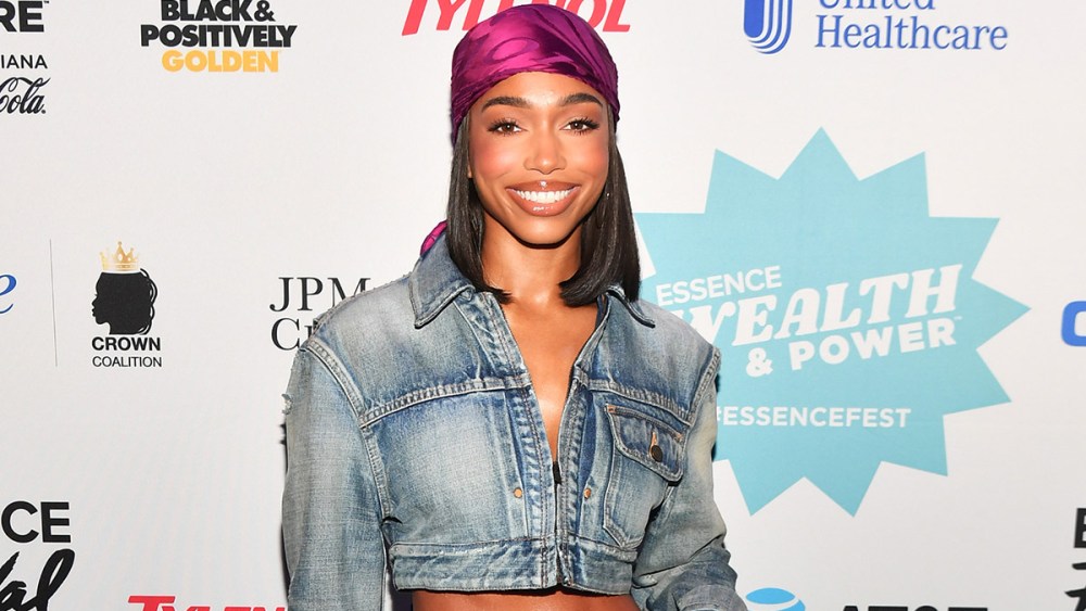 Lori Harvey wears APC distressed jeans, cropped ysl saint laurent jacket, hermes crocodile burgundy mini bag and tom ford naked sandals in crocodile leather and gold padlock strap and gold spike heels attends the 2022 Essence Festival of Culture at the Ernest N. Morial Convention Center on July 1, 2022 in New Orleans, Louisiana. (Photo by Paras Griffin/Getty Images for Essence)