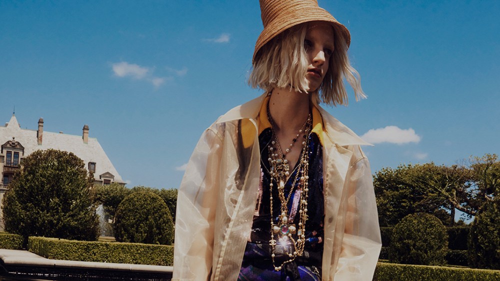 Rejina Pyo's clear crinoline coat over Plan C's polyester sequins, cotton and nylon top; Marine Serre's wool skirt. Esenchel hat; Hunter boots; Chanel necklaces and ring.