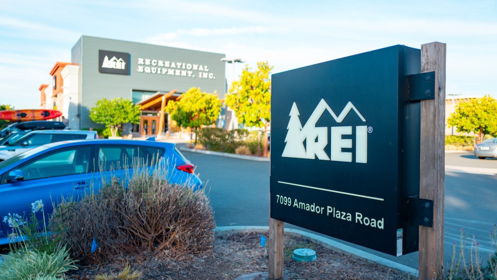 Close-up of sign for Recreational Equipment Incorporated (REI) outdoor clothing store, with facade of store in background, in Dublin, California, July 23, 2018. (Photo by Smith Collection/Gado/Sipa USA)(Sipa via AP Images)
