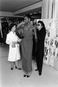 Designer Hanae Mori adjusts garments on a model Gloria Burgess for the Hanae Mori Spring 1983 Couture collection.