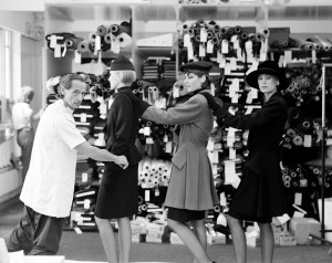 Designer Marc Bohan adjusts garments on a models for the Dior Fall 1985 Couture Collection Advance.