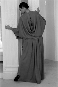 A model poses in a draped back evening gown designed by Alix Gres for Fall 1980.