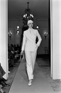 A model poses in a double-breasted pant suit from the Dior spring 1977 couture collection designed by Marc Bohan.