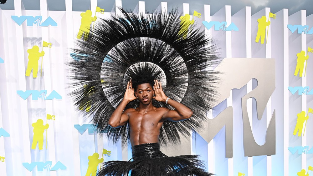 Lil Nas X wearing feathered harry reed skirt and head piece at the 2022 MTV Video Music Awards held at Prudential Center on August  28, 2022 in Newark, New Jersey.