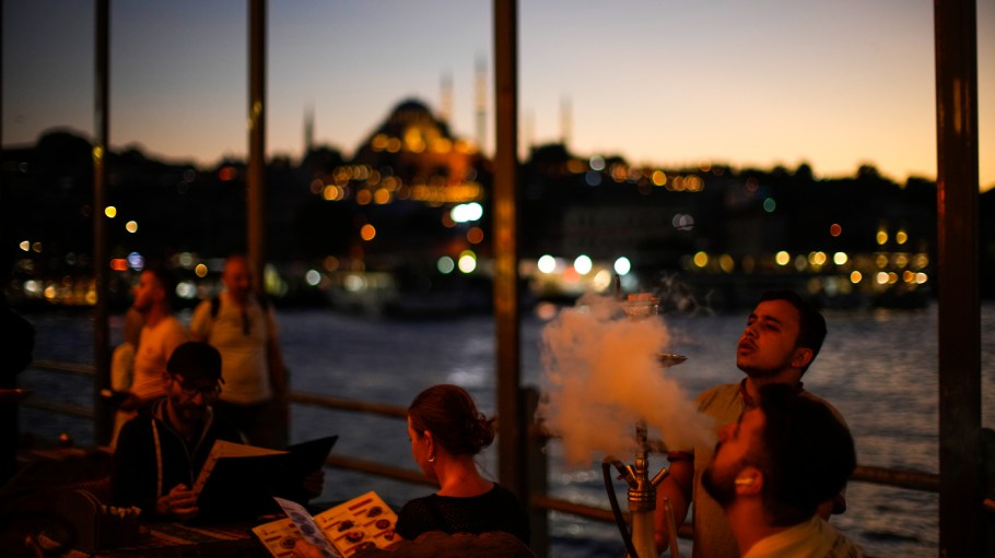 A waiter prepares a water pipe for a customer at Galata bridge in Istanbul, Turkey, Monday, Sept. 5, 2022. Turkey's annual inflation passed 80% in August, according to official data on Monday, further hitting consumers facing high energy, food and housing costs.
