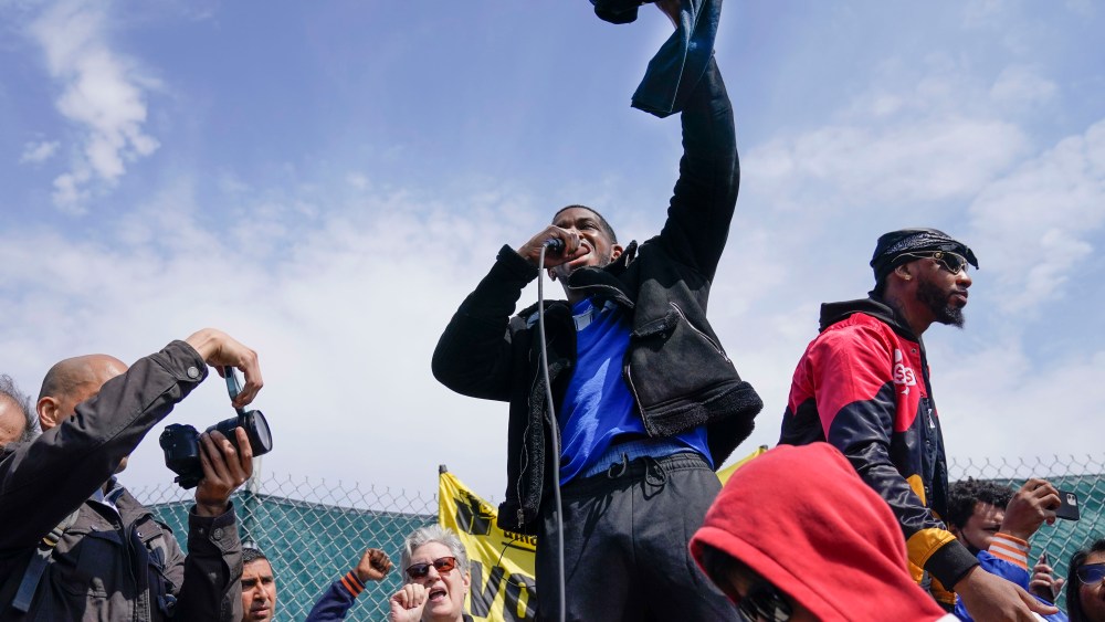 FILE — Union organizer Derrick Palmer speaks at a rally outside an Amazon warehouse, in Staten Island borough of New York, April 24, 2022. Amazon has suspended at least 50 warehouse workers who refused to work their shifts following a trash compactor fire at the facility, Tuesday, Oct. 4, 2022, according to Palmer, the vice president of the Amazon Labor Union. (AP Photo/Seth Wenig, File)