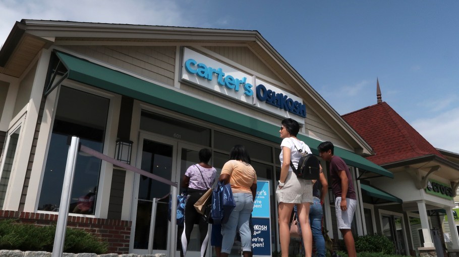 People wait to enter the the carters and OSH KOSH store at the Woodbury Common Premium Outlets shopping mall.