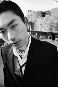 Briony Raymond’s platinum south sea pearl and diamond drop earring; Yutai’s cultured akoya pearl and platinum necklace. Celine mohair and virgin wool suit and cotton shirt. Celine tie and crystal necklace; Alexander McQueen boots.
