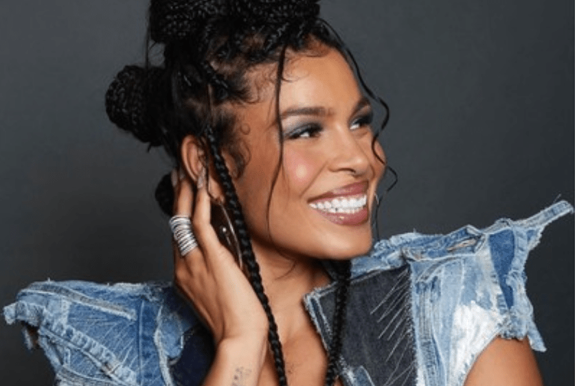 Jordin Sparks with braids in her hair posing.