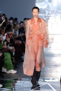 BERLIN, GERMANY - JANUARY 17: A model walks the runway wearing coat by Tribal Hotel, body by Anekdot, shoes by Anima Protection at the VORN -The Berlin Fashion Hub x NEWEST runway show during the Berlin Fashion Week AW23 at Kant-Garagen on January 17, 2023 in Berlin, Germany. (Photo by Andreas Rentz/Getty Images for NEWEST 2023)