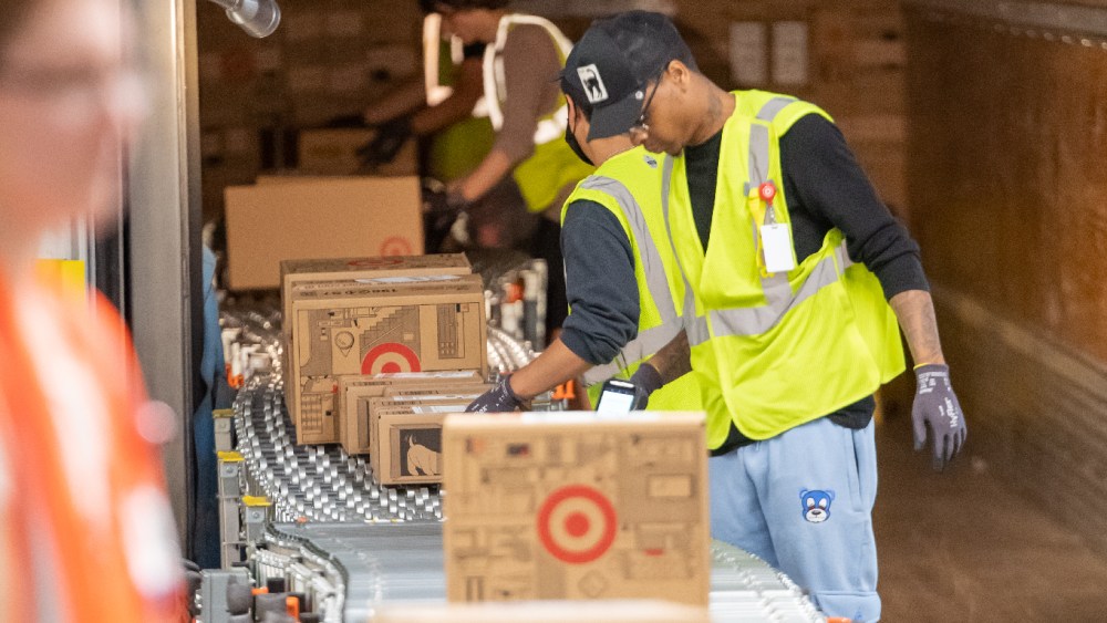 target boxes on conveyor belt workers sortation delivery