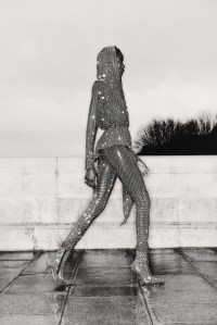 Alexandre Vauthier’s jersey hooded couture jacket and leggings with crystals and crystal boots. Metamorphosis by De Beers Prelude ring in platinum and 18-karat yellow gold, set with a Fancy Vivid orange-yellow cushion-cut diamond and white diamonds.