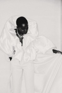 Ronald van der Kemp’s upcycled wool crepe couture jacket with giant silk duchess ruffles and upcycled wool satin pants with satin duchess train. Cartier Beautés du Monde necklace/brooch with platinum, eight cabochon-cut emeralds from Zambia and Ethiopia, cushion-shaped sugarloaf spinels, onyx and brilliant-cut diamonds.