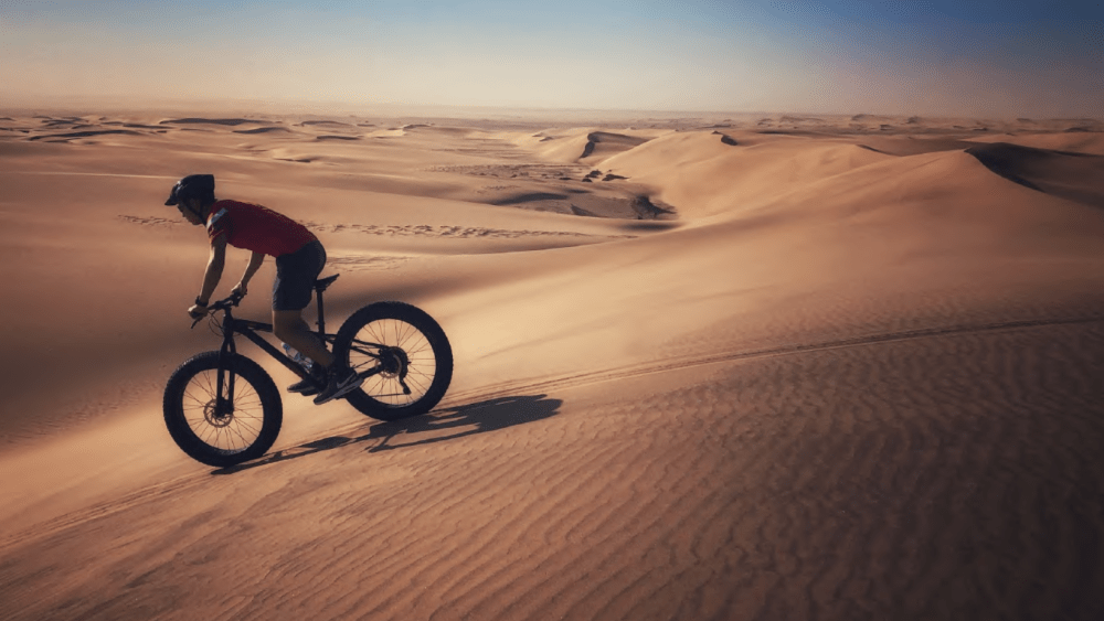 A cyclist rides the dunes near AlUla in Saudi Arabia.