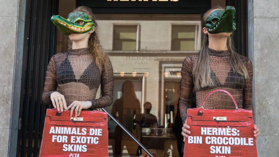 Two PETA supporters wearing Venetian crocodile masks pose outside the Hermès store in New Bond Street in protest against the luxury fashion house's use of exotic skins on Sept. 8, 2021.