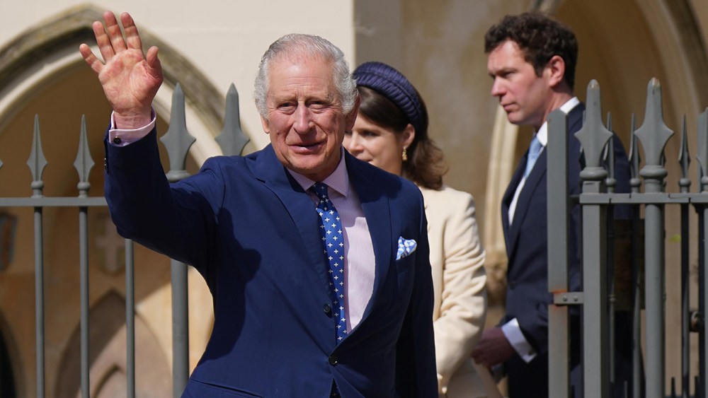 King Charles III waving to the crowds following the 2023 Easter service at Windsor Castle.
