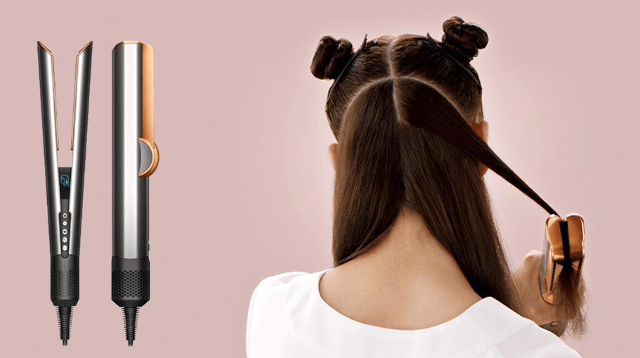 Back of a woman's head who is using Dyson Airstrait hair tool styling straightener