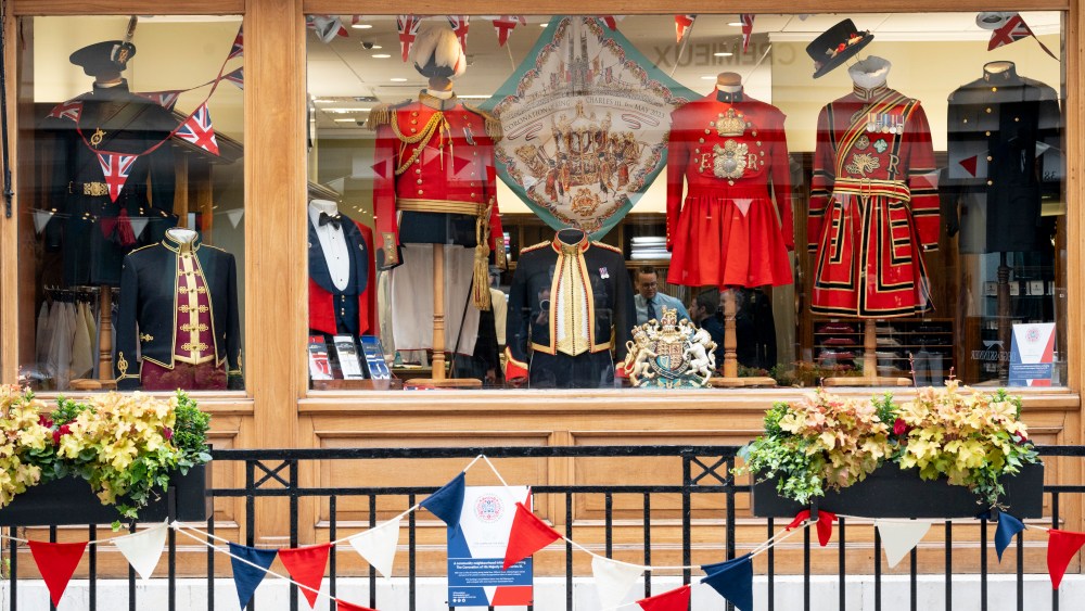 With five days to go before the coronation of King Charles III, military ceremonial uniforms are displayed in the window of Dege & Skinner in Savile Row, London, England.