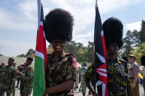 PIRBRIGHT, ENGLAND - MAY 04: Kenyan soldiers wear bearskin hats belonging to British Guardsmen as they pose for a photograph being taken by a colleague after a military parade for representatives of the Commonwealth taking part in the Coronation of King Charles III at Army Training Centre Pirbright on May 4, 2023 in Pirbright, England. (Photo by Carl Court/Getty Images)