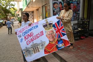 Art school students carry a painting depicting Britain's King Charles III ahead of his coronation, in Mumbai on May 5, 2023. - King Charles III will be crowned alongside wife Camilla on May 6, in a centuries-old ceremony with celebrations marked by pomp and pageantry. (Photo by INDRANIL MUKHERJEE / AFP) (Photo by INDRANIL MUKHERJEE/AFP via Getty Images)