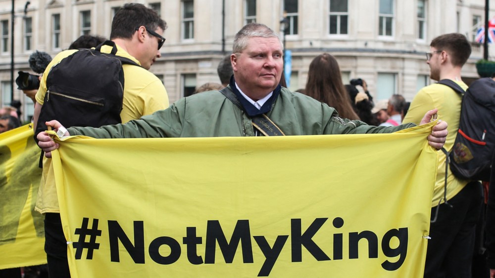 Protesters hold up placards saying "Not My King" in Trafalgar Square close to where Westminster Abbey, where the coronation was held.