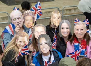 Spectators with Royal masks ahead of the coronation ceremony of King Charles III and Queen Camilla in central London. Picture date: Saturday May 6, 2023. (Photo by Lesley Martin/PA Images via Getty Images)