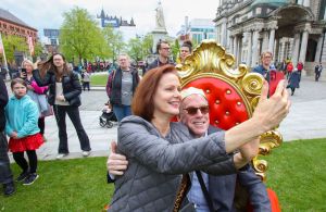 Members of the public gather in the grounds of Belfast City Hall, to watch the Coronation Ceremony for the new King and Queen, Britain's King Charles III and Britain's Queen Camilla, in Belfast on May 6, 2023. - The set-piece coronation is the first in Britain in 70 years, and only the second in history to be televised. Charles will be the 40th reigning monarch to be crowned at the central London church since King William I in 1066. Outside the UK, he is also king of 14 other Commonwealth countries, including Australia, Canada and New Zealand. Camilla, his second wife, will be crowned queen alongside him and be known as Queen Camilla after the ceremony. (Photo by PAUL FAITH / AFP) (Photo by PAUL FAITH/AFP via Getty Images)
