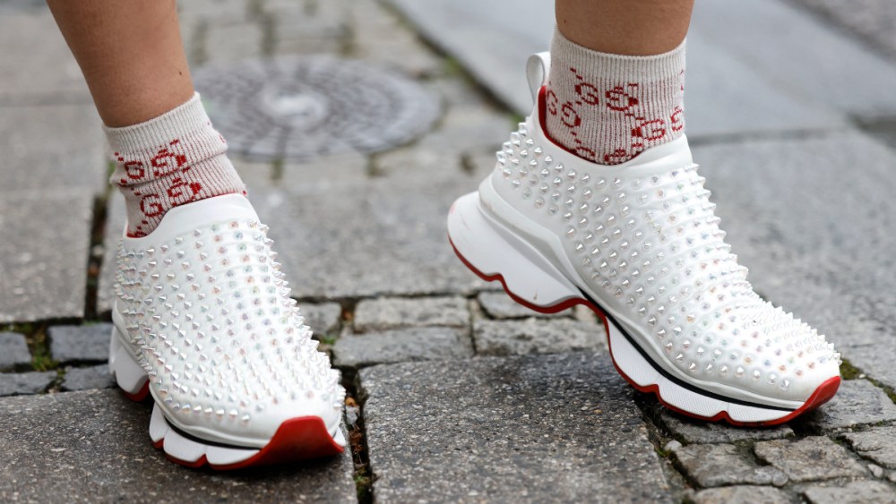 White studded sneakers by Louboutin seen in Munich.