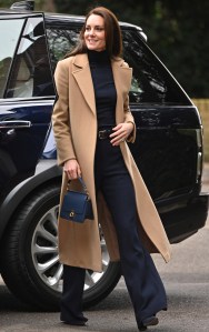 Kate wore a Mac & Co coat, navy turtleneck, Roland Mouret pants, Emmy London pumps and a Polène Paris bag for a nursery home visit.