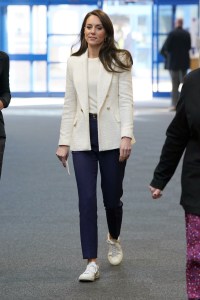 Visiting the Landau Forte College in Derby, Kate wore a Zara blazer, white knit top, navy trousers, and Veja sneakers.