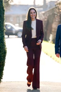 While hosting a rugby reception at Hampton Court Palace, Kate looked sharp in a bordeaux Roland Mouret suit and matching Gianvito Rossi heels, paired with jewelry from Daniella Draper.